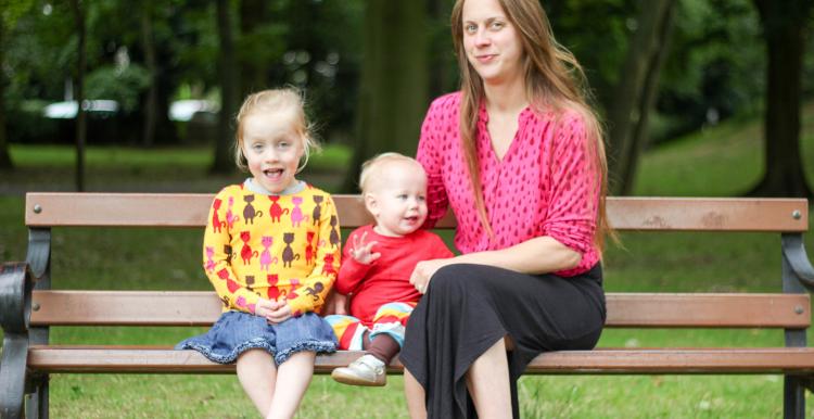 Woman with children sitting on a bench