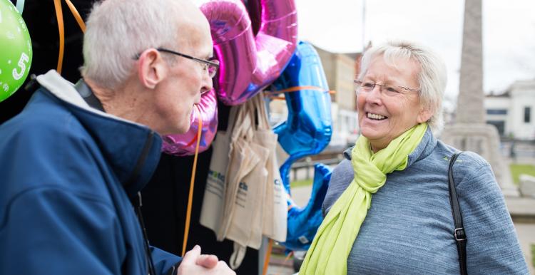 Volunteer talking to member of the public