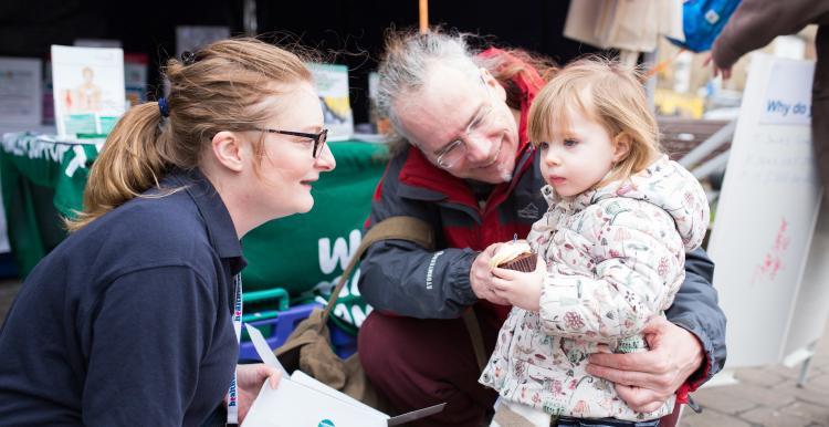 Volunteer speaking with small child