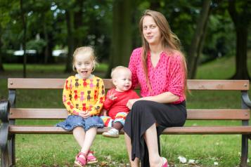 Woman with children sitting on a bench