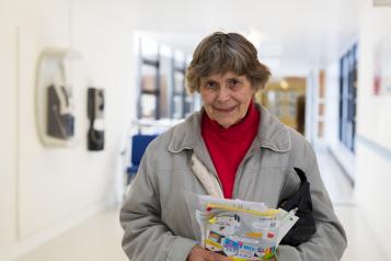 Older lady leaving hospital with info pack