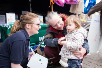Volunteer speaking with small child