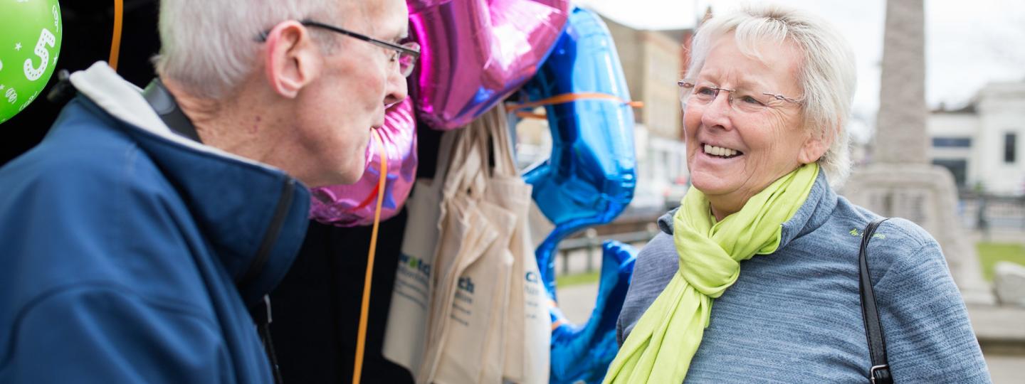 Volunteer talking to member of the public