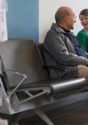 Two people talking in a waiting room