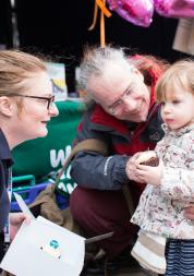Volunteer speaking with small child